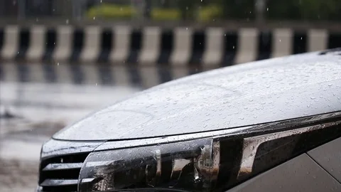 Close up front of car parking at outdoor while raining Stock Footage 76237411