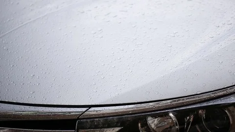 Close up front of car parking at outdoor while raining Stock Footage 76237429
