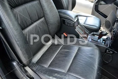 Close-up on the front car seat with black leather trim, of used vehicle in ba Stock Photos
