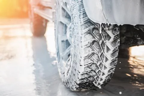 Close-up of the front of a car wheel with soap suds, car body cleaning chemicals Stock Photos