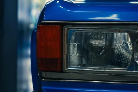 Close-up of front halogen headlights of classic car in garage Stock Photos