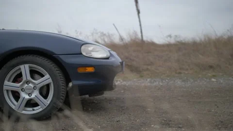 Close up of front of Mazda MX5/Miata car rolling in slow motion introduction Vídeo Stock 201415848