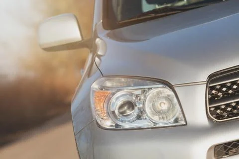 Close up front new silver SUV car. Detail of a modern car. Head light Stock Photos