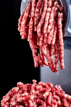 Close up front part of mincing-machine with mincemeat in Stock Photos