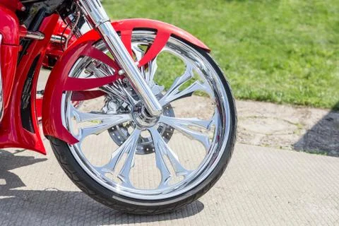 Close-up front part of retro custom motorcycle. Shining chrome vintage bike Stock Photos