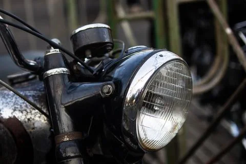 Close up front side view of classic vintage motorcycle headlight with chrom.. Stock Photos