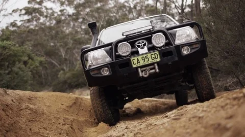 Close front view of 4WD in a forest with wheel spin Stock Footage 81604637