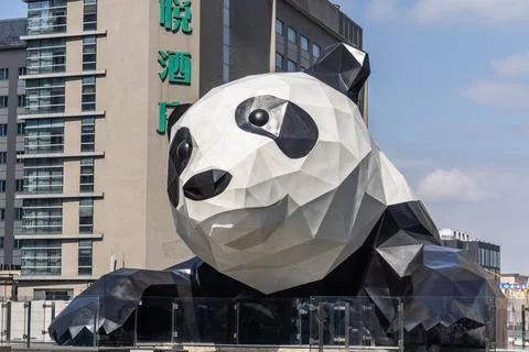 Close-up front view and face of Giant Panda clinging onto the IFS Mall building Stock Photos