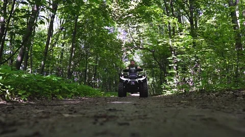 Close up. Front view. The ATV rides on the road on the camera. Stock Footage 139884413