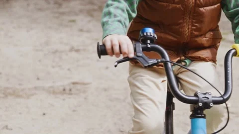 Close up front view of boy hands on handlebar during cycling Stock Footage 316581483