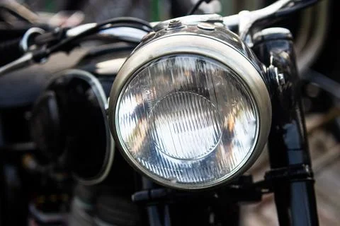 Close up front view of classic black motorcycle glass headlight lens with c.. Foto stock
