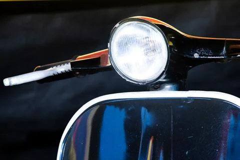 Close up front view of classic vintage black scooter round headlight and ha.. Stock Photos