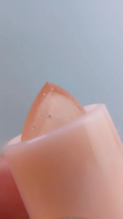 Close up front view of clear lip balm with pink packaging slowly coming out.. Stock Footage 340077307