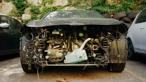 Close up front view of a dismantled car with exposed engine components, hoses, Stock Footage 339733937
