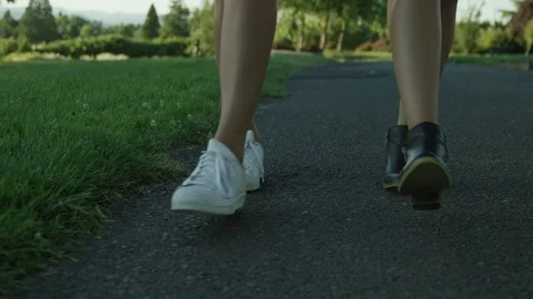 Close Up Front View of Feet and Legs Walking on a Park Path in Slow Motion Stock Footage 75458199