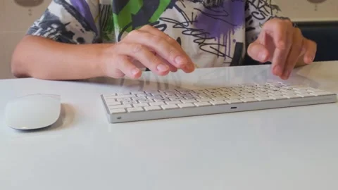 Close-up front view of female hands typing on computer keyboard at desk. Work Stock Footage 333769726