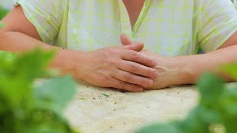Close up front view hands of an elderly woman lie on a flat surface Stock Footage 266111882