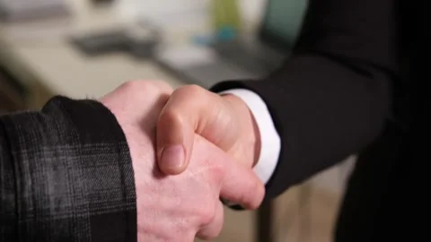 A close-up front view of a handshake at work Stock Footage 318222110