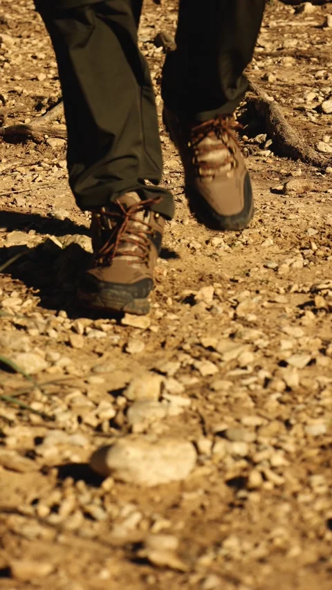 Close up front view of a man's shoes walking on a rocky in the mountain trail Stock Footage 296273464