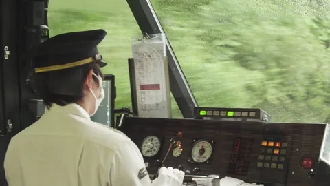 Close-up Front View of a Moving Train with Conductor in Japan Stock Footage 105415753