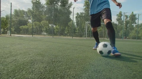 Close-up front view of soccer player legs in football boots with ball Stock Footage 157672648