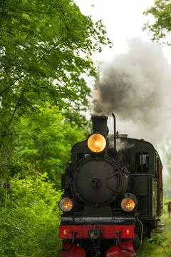 Close up front view of steaming vintage locomotive. Stock Photos