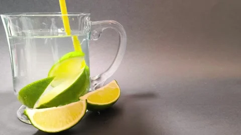 Close up front view of stirring water inside a glass cup mug with a straw a.. Video stock 318127579