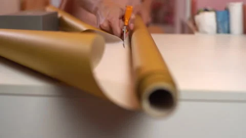 Close-up front view of unrecognizable young woman cutting with scissors wrapping Stock Footage 164035329