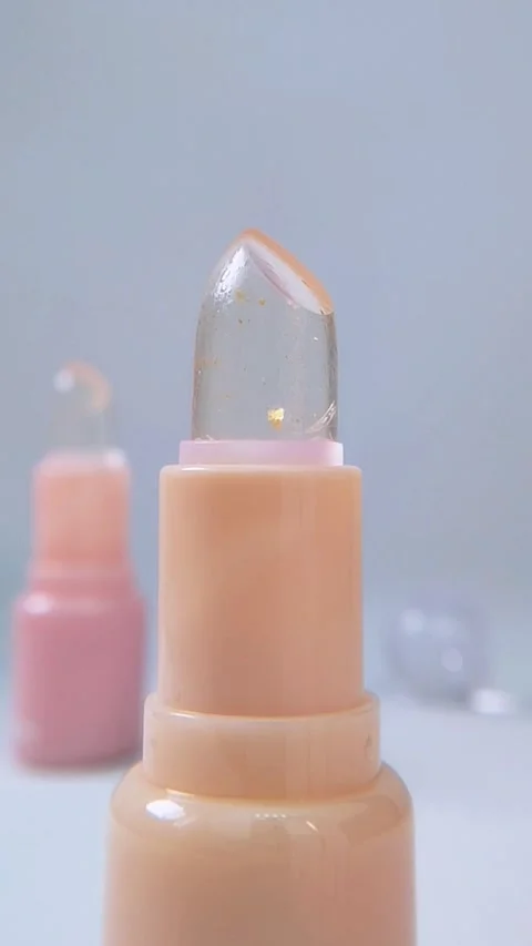 Close up front view of yellow and pink lip balm products neatly arranged on.. Stock Footage 340260680