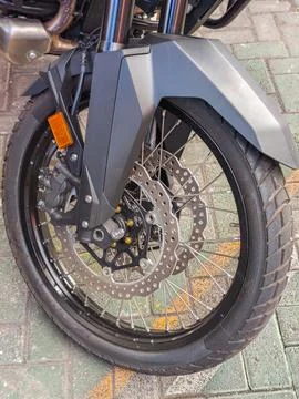 Close Up Front Wheel and Disc Brake System of Adventure Motorcycle Stock Photos