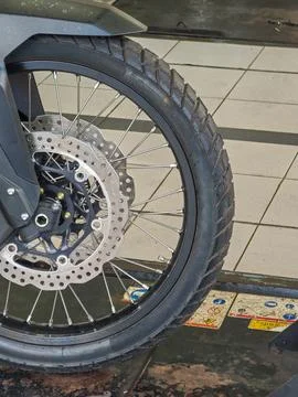Close Up Front Wheel and Disc Brake System of Adventure Motorcycle Stock Photos