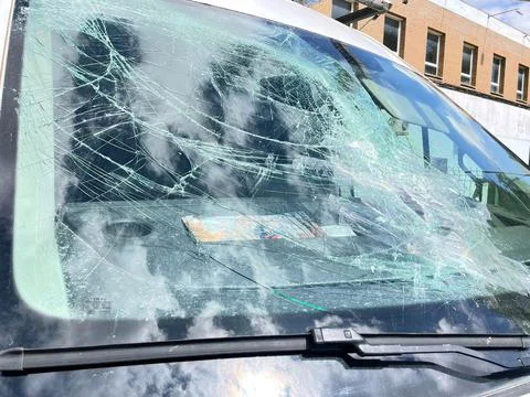Close-up of a front window of a van broken by a rock Stock Photos