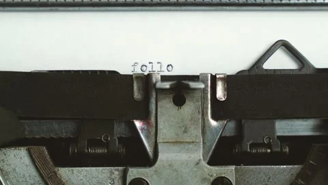 Close up frontal view typing text " follow us " on a old typewriter Stock-Footage 149347629