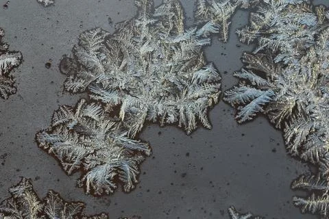 Close-Up of Frost Patterns on a Dark Surface in Winter 写真素材