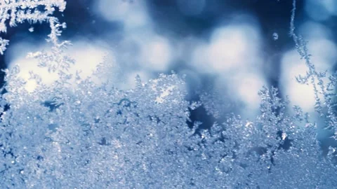 Close-up frosty pattern on the window on a winter day Stock Footage 232889677