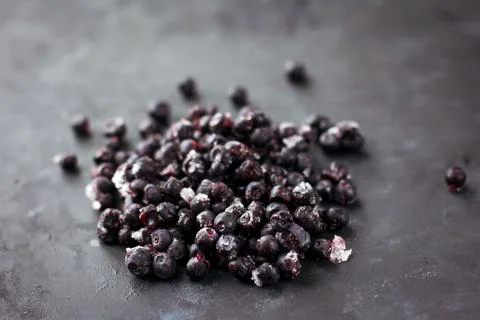 Close up of frozen blueberries on a black table Stock Photos