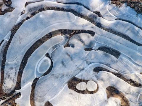 Close-up of frozen puddle ice pattern Stock Photos