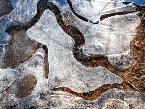 Close-up of frozen puddle ice pattern Stock Photos