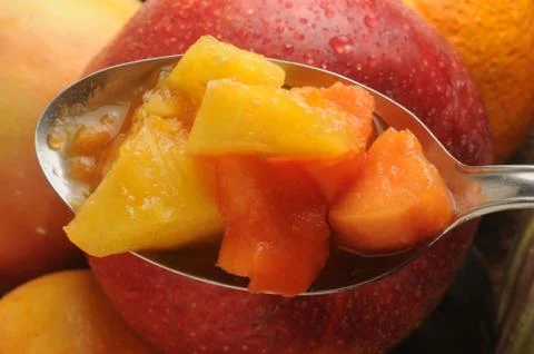 Close up on fruit salad in spoon Stock Photos