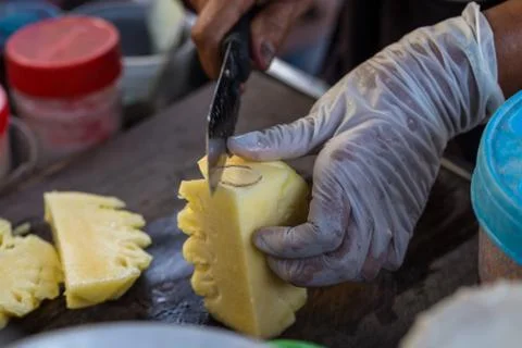 Close up Fruit traders are cutting pineapple for sale. Street Food in Thailan Stock Photos