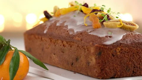 Close-up. A fruitcake soaked in rum is on the table. Christmas atmosphere with Video stock 145368103