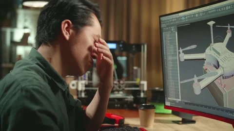 Close Up Of Frustrated Asian Engineer Working On Personal Computer And 3D Stock Footage 158105739