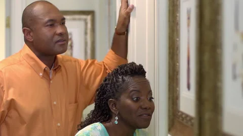 Close up of frustrated black couple knocking on bathroom door in house Stock Footage 191362885