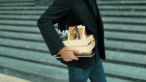 Close up of frustrated worker walking outside carrying wooden box. Male burnout 스톡 동영상 346997611