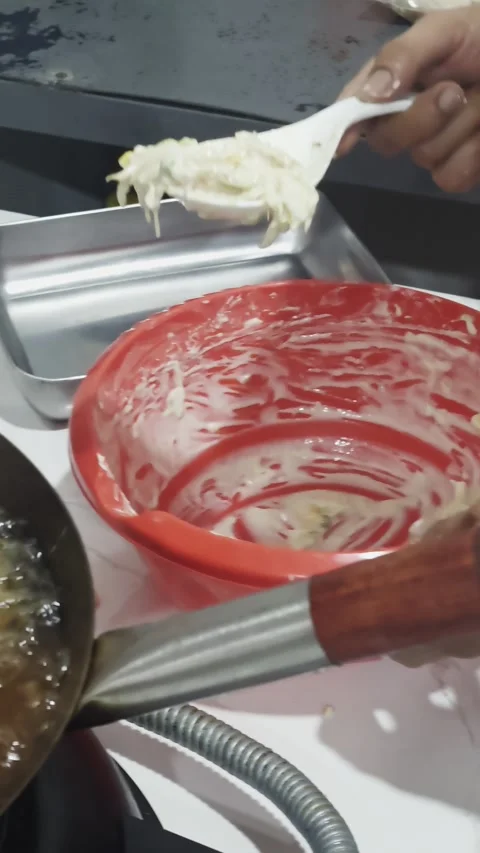 Close-up of Frying Crispy Cabbage Fritters in Hot Oil Using a Wok Video stock 329145501