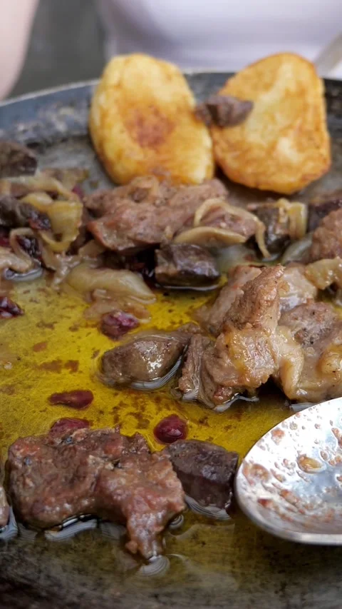 Close up of frying lamb meat with fried potatoes and cranberry Stock Footage 341446209