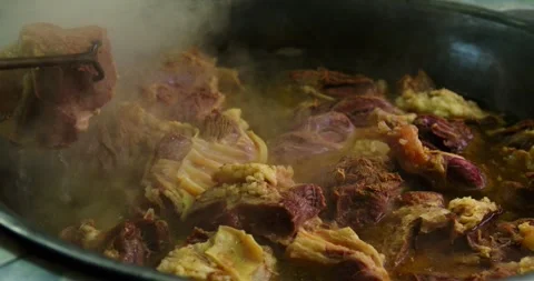 Close Up of Frying Meat in Cauldron for Plov Stock Footage 346803633