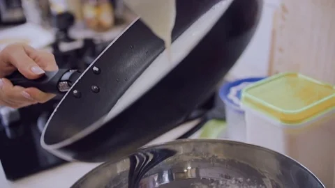 A close-up of a frying pan on which pour out the dough for pancakes. Stock Footage 77523621