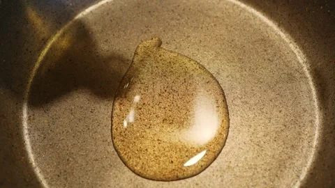 Close-up of frying pan on which vegetable oil is poured for cooking, nonstick Stock Footage 283803863