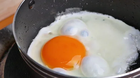 Close-up of frying tasty fried egg in a hot pan. Stock Footage 157199357